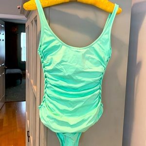 Mint swimsuit with cute woven details on side.